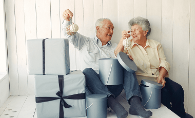 elegant-old-couple-sitting-home-with-christmas-gifts 1 (1)