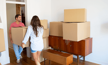 family-couple-leaving-their-apartment-carrying-carton-boxes-furniture 1