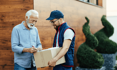 happy-senior-man-receiving-packages-signing-postman-home-delivery 1 (1)