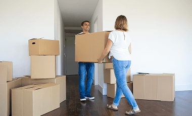 married-couple-leaving-apartment-carrying-cartoon-box-entrance-together 1